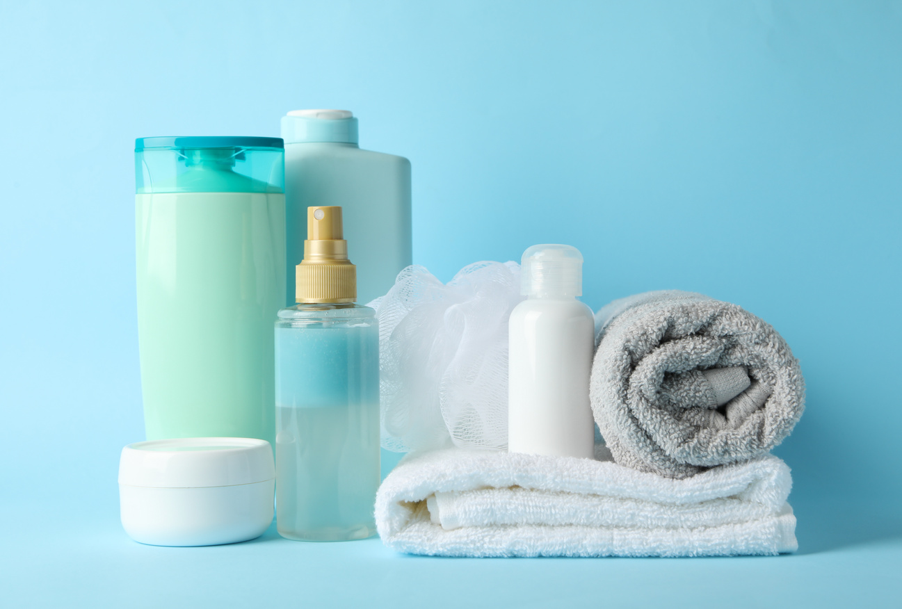 Body care products on blue background. Personal hygiene